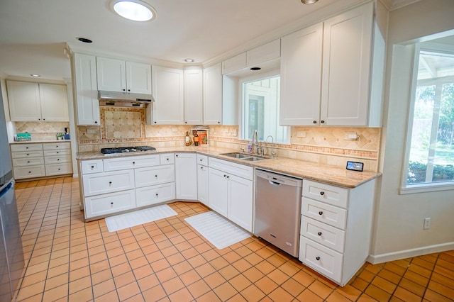 kitchen featuring appliances with stainless steel finishes, white cabinetry, and sink