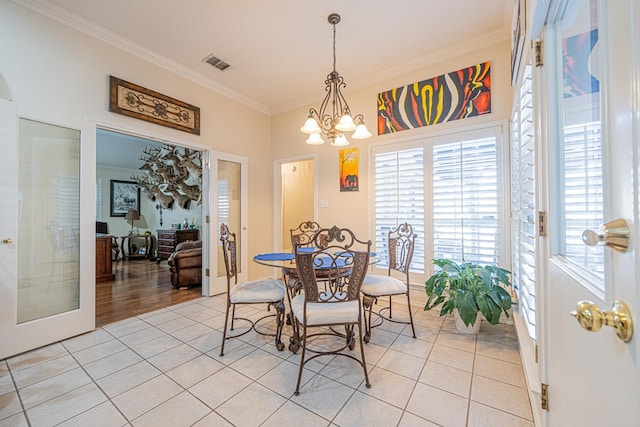 dining room featuring french doors, crown molding, light tile patterned floors, visible vents, and an inviting chandelier