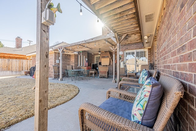 view of patio with fence, an outdoor living space, and ceiling fan