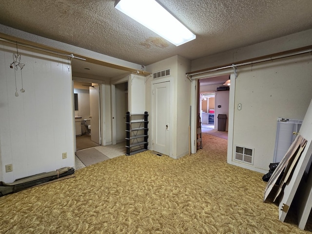 6101 Fm 715, Midland, TX 79706 - basement featuring a textured ceiling and carpet floors