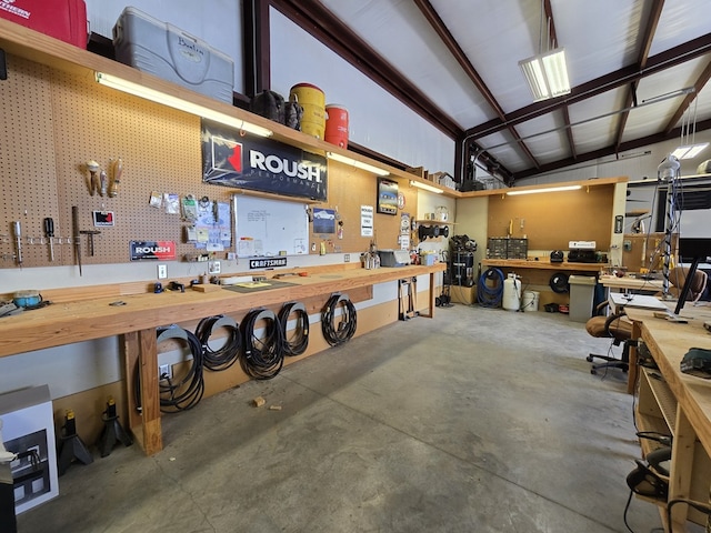 6101 Fm 715, Midland, TX 79706 - miscellaneous room featuring a workshop area, concrete floors, and vaulted ceiling