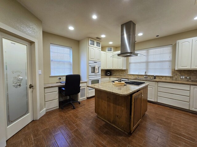 6101 Fm 715, Midland, TX 79706 - kitchen featuring island range hood, white double oven, tasteful backsplash, white cabinetry, and recessed lighting