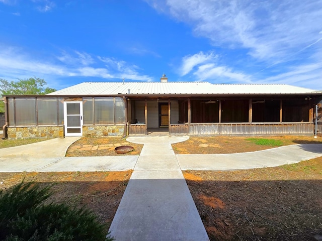 6101 Fm 715, Midland, TX 79706 - view of front facade with metal roof, a chimney, and covered porch