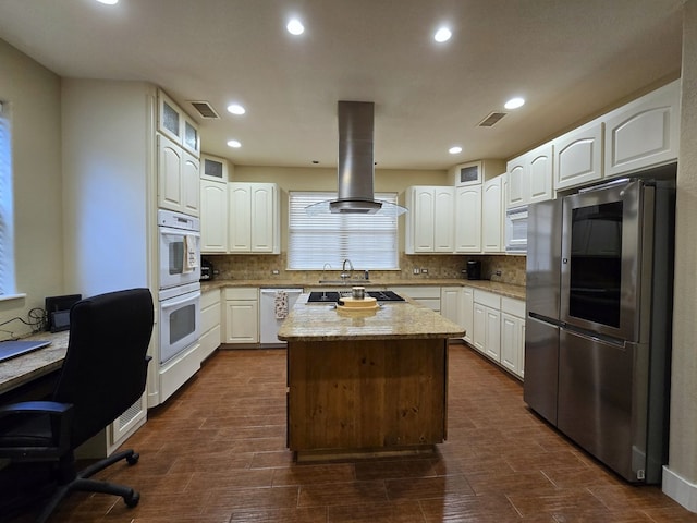 6101 Fm 715, Midland, TX 79706 - kitchen featuring appliances with stainless steel finishes, island exhaust hood, white cabinetry, decorative backsplash, and recessed lighting