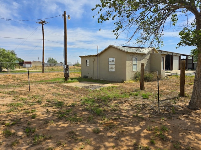 6101 Fm 715, Midland, TX 79706 - view of home's exterior with stucco siding, a garage, and metal roof