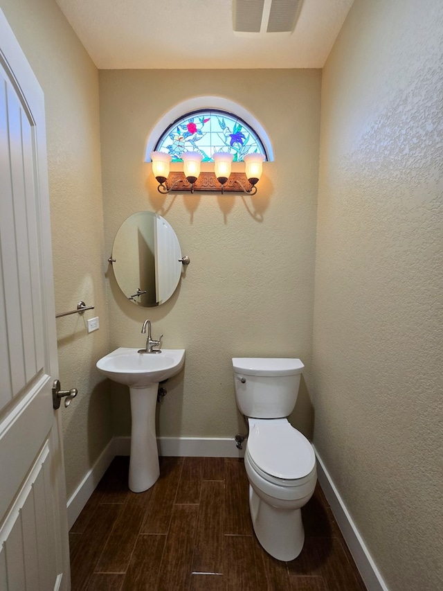 6101 Fm 715, Midland, TX 79706 - bathroom with toilet, wood finished floors, and baseboards