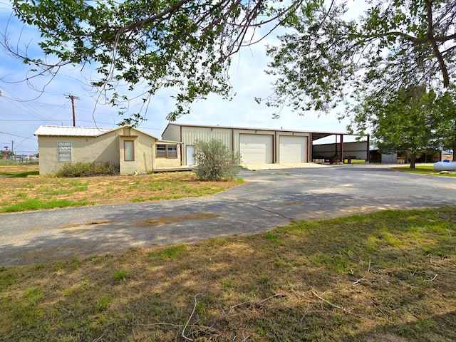 6101 Fm 715, Midland, TX 79706 - view of front facade featuring asphalt driveway, a garage, a carport, and stucco siding