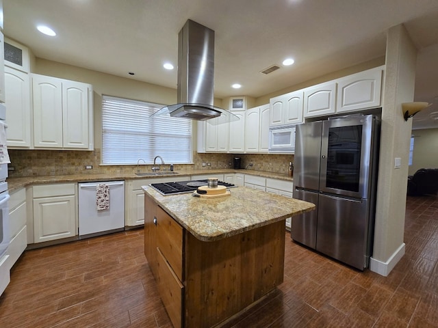 6101 Fm 715, Midland, TX 79706 - kitchen featuring appliances with stainless steel finishes, island range hood, a sink, light stone counters, and a center island