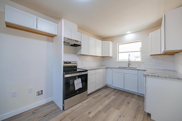 kitchen with sink, white cabinetry, electric range, light stone countertops, and light wood-type flooring