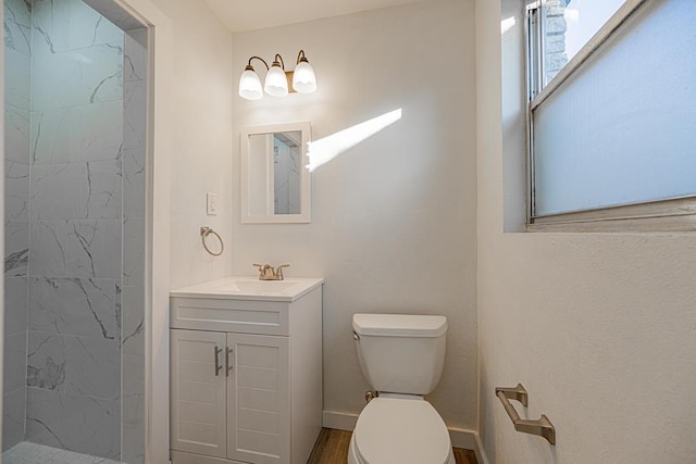 bathroom featuring vanity, wood-type flooring, toilet, and walk in shower