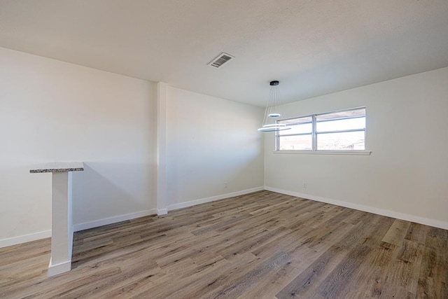 unfurnished room with light hardwood / wood-style flooring