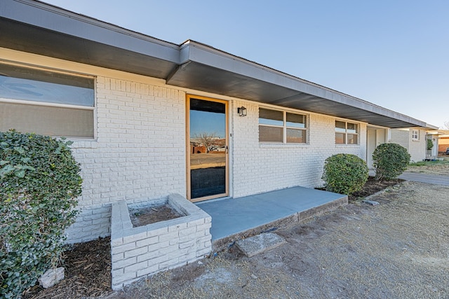 property entrance featuring a patio area