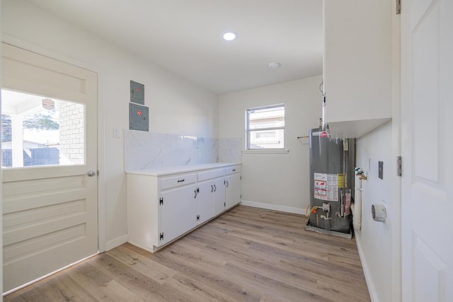 washroom with gas water heater and light wood-type flooring