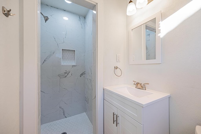 bathroom featuring vanity and a tile shower