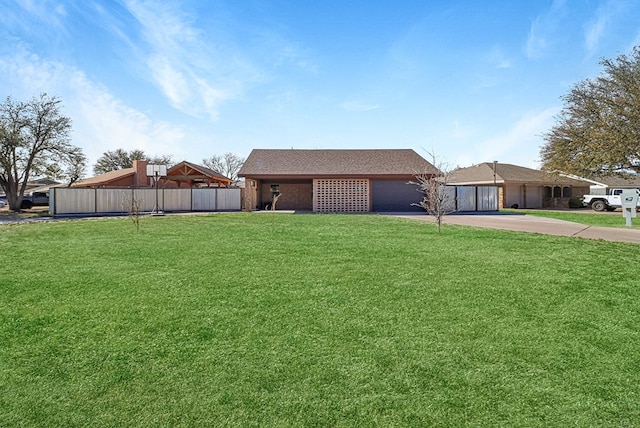 exterior space with driveway, an attached garage, a front yard, and fence