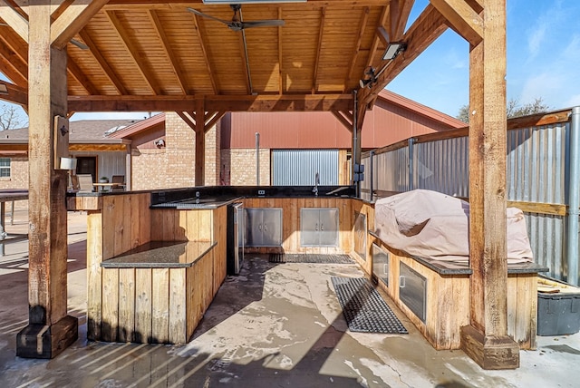 view of patio with area for grilling and a grill