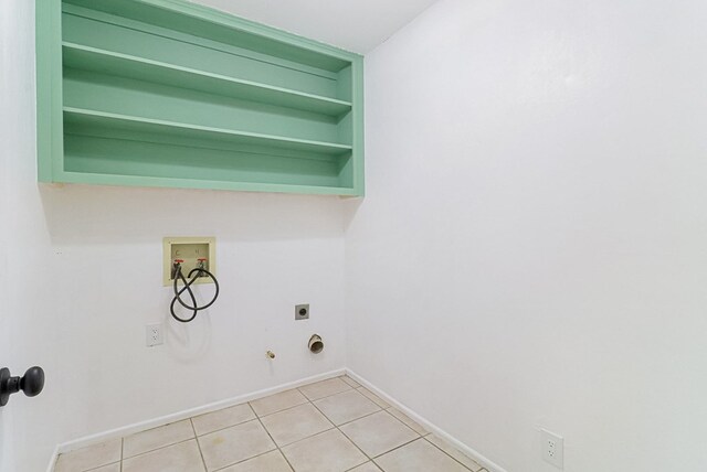 clothes washing area with hookup for a washing machine, light tile patterned floors, gas dryer hookup, hookup for an electric dryer, and laundry area