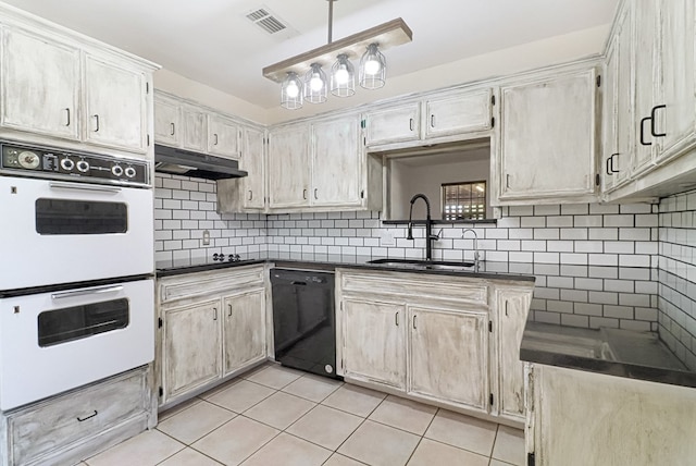 kitchen with visible vents, under cabinet range hood, light tile patterned floors, black appliances, and a sink