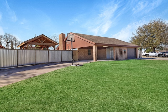 exterior space featuring a gazebo, an attached garage, and driveway