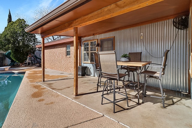 view of patio featuring outdoor dining area and an outdoor pool