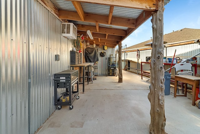 view of patio featuring a wall unit AC