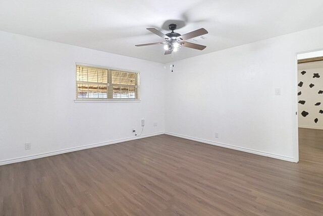 empty room featuring ceiling fan, baseboards, and dark wood-style floors