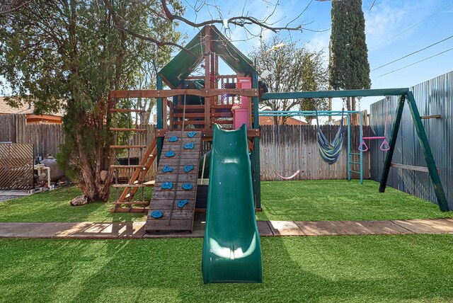 view of play area featuring a fenced backyard and a lawn