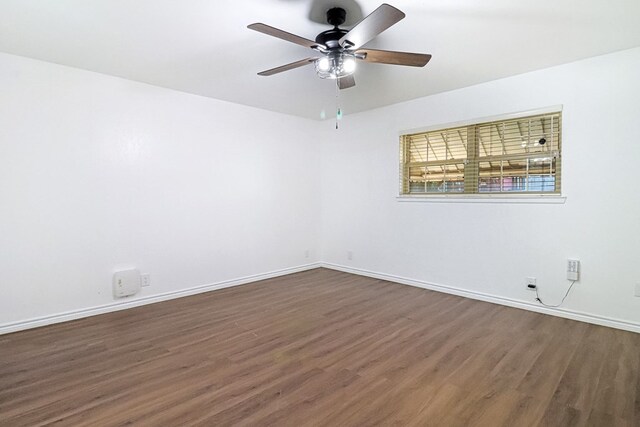 unfurnished room featuring ceiling fan, baseboards, and wood finished floors