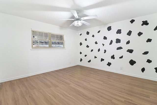 unfurnished room with light wood-style floors, baseboards, and ceiling fan