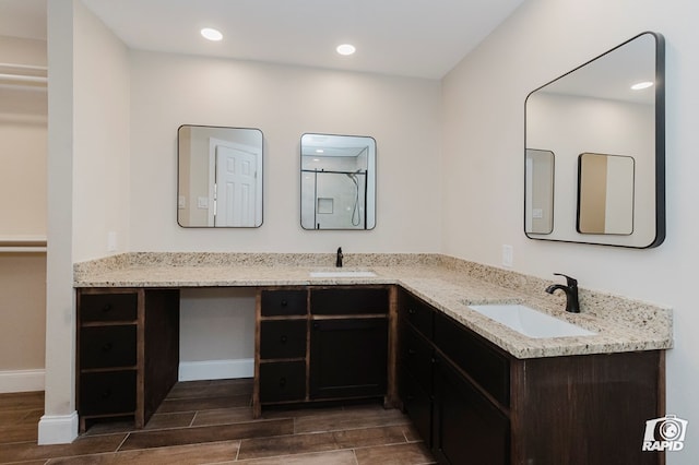 bathroom with recessed lighting, a sink, and wood tiled floor