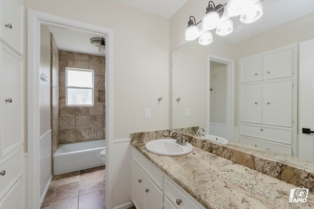 full bath featuring vanity, washtub / shower combination, and toilet