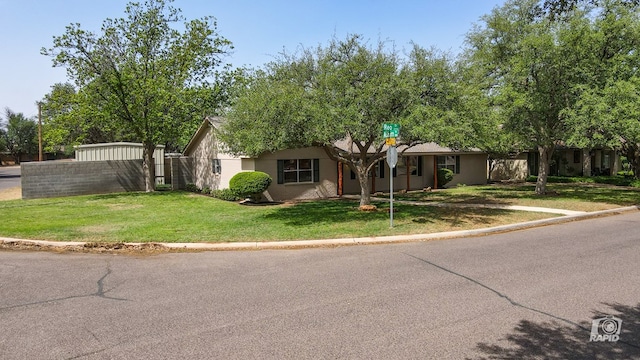 single story home featuring fence and a front yard
