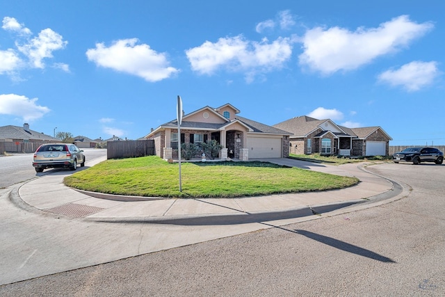 ranch-style home with a front yard and a garage