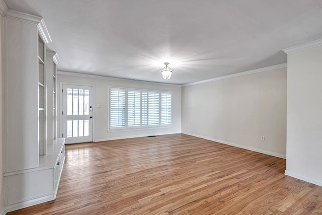 2008 Bedford Dr, Midland, TX 79701 - spare room featuring light wood-type flooring, ornamental molding, and baseboards