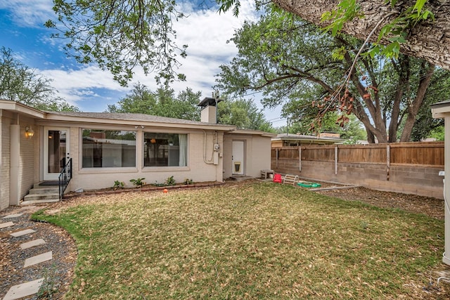2008 Bedford Dr, Midland, TX 79701 - back of property with a chimney and brick siding