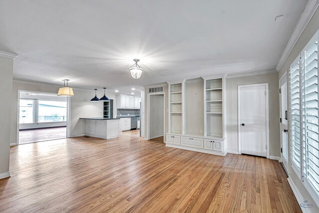 2008 Bedford Dr, Midland, TX 79701 - unfurnished living room with light wood-type flooring, crown molding, baseboards, and a chandelier