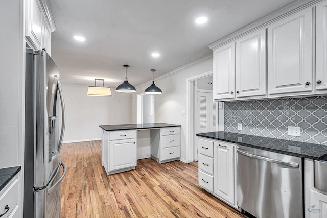 2008 Bedford Dr, Midland, TX 79701 - kitchen with appliances with stainless steel finishes, dark countertops, backsplash, white cabinetry, and light wood finished floors