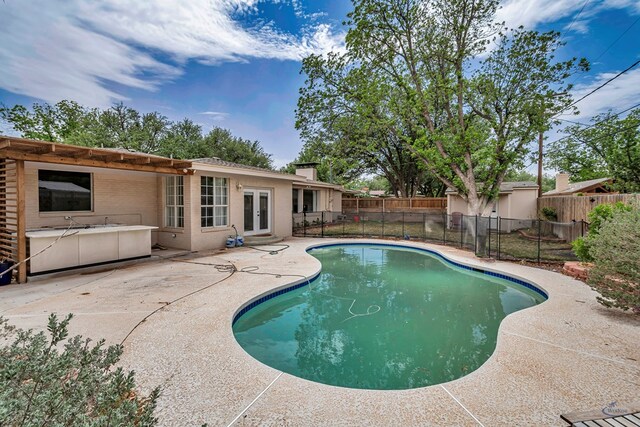 2008 Bedford Dr, Midland, TX 79701 - view of pool featuring french doors, a patio, and a fenced backyard
