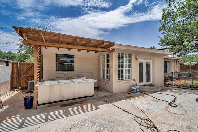 2008 Bedford Dr, Midland, TX 79701 - back of house with a gate, brick siding, french doors, and a patio