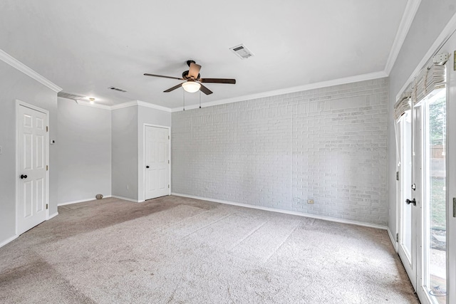 2008 Bedford Dr, Midland, TX 79701 - spare room with brick wall, ornamental molding, carpet flooring, a ceiling fan, and baseboards