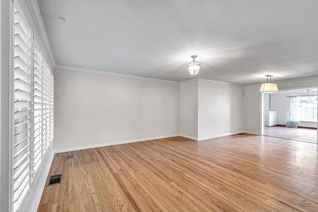 2008 Bedford Dr, Midland, TX 79701 - unfurnished living room with light wood-type flooring, baseboards, and ornamental molding