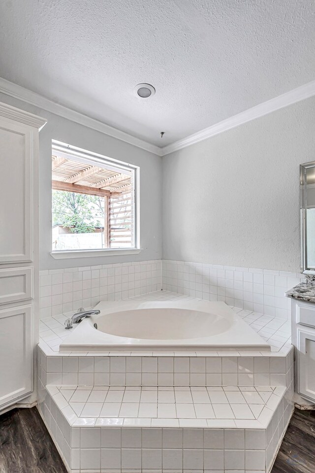 2008 Bedford Dr, Midland, TX 79701 - full bath featuring wood finished floors, a textured ceiling, ornamental molding, a bath, and vanity