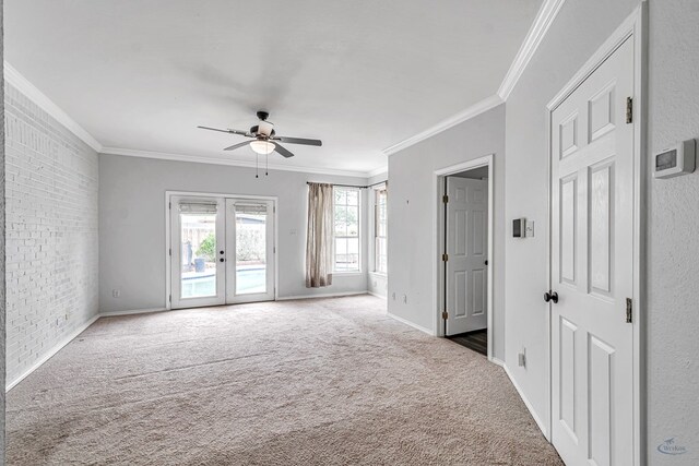 2008 Bedford Dr, Midland, TX 79701 - carpeted spare room with a ceiling fan, crown molding, french doors, baseboards, and brick wall