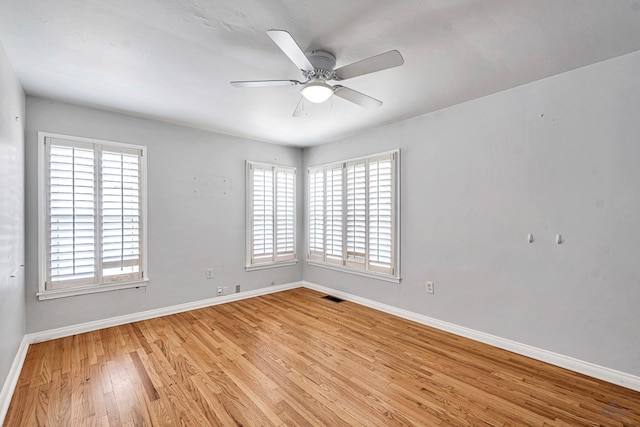 2008 Bedford Dr, Midland, TX 79701 - empty room with healthy amount of natural light, light wood-style floors, and baseboards