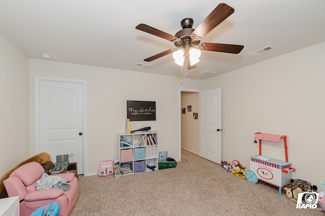 recreation room featuring carpet flooring, visible vents, and a ceiling fan