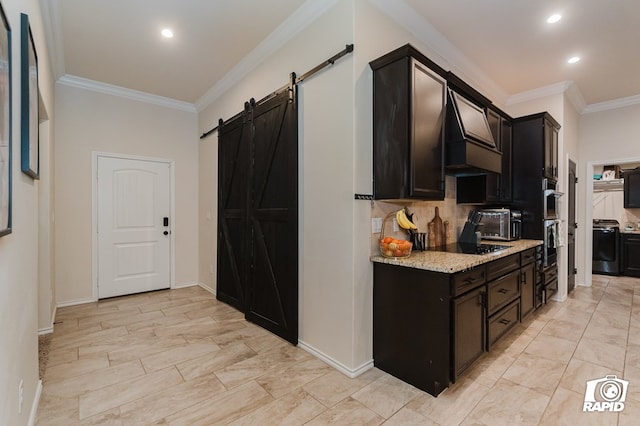 kitchen with light stone counters, crown molding, custom range hood, backsplash, and a barn door