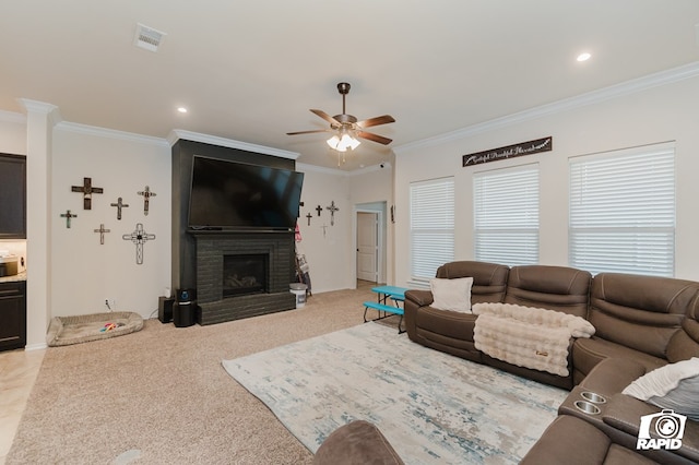 living area with a large fireplace, light carpet, visible vents, a ceiling fan, and ornamental molding