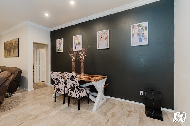 dining room with crown molding, an accent wall, recessed lighting, and baseboards