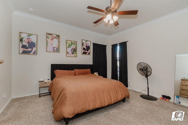 carpeted bedroom featuring ornamental molding, a ceiling fan, and baseboards