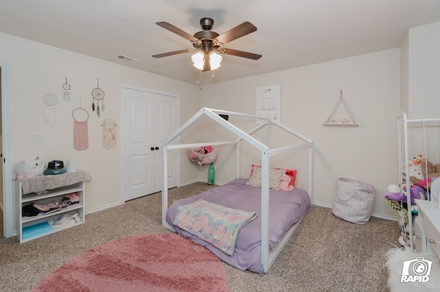 carpeted bedroom featuring baseboards, ceiling fan, visible vents, and a closet